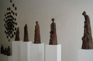 A view of Joe Geraldo's mask installation and terracotta figures