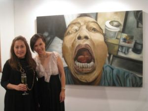 Tina Fernandez and Michelle Tomacruz with a Tatong Torres self portrait at the Art Informal booth