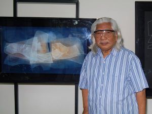 Romulo Olazo with one of his diaphanous paintings